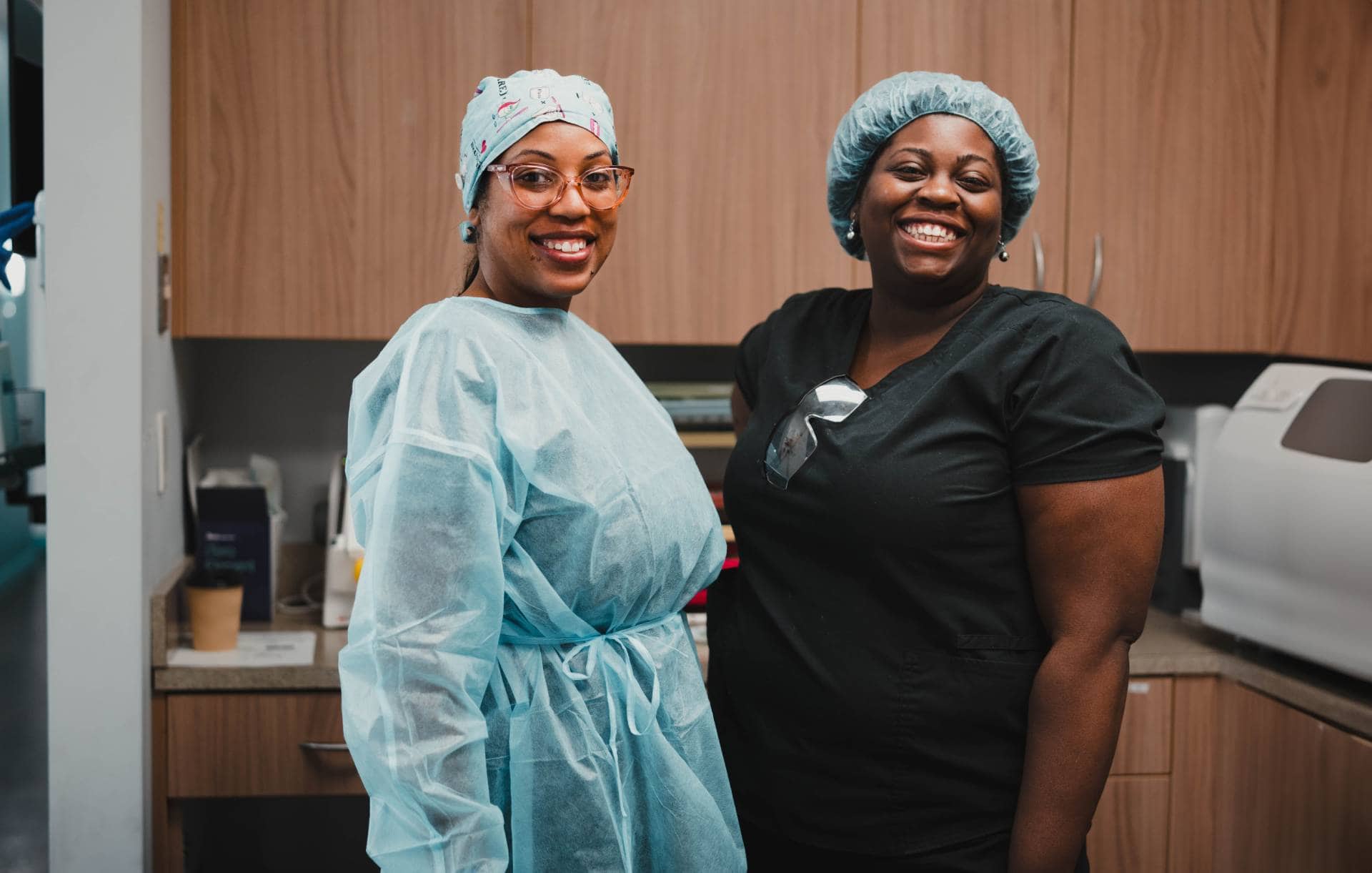 Two team members smiling